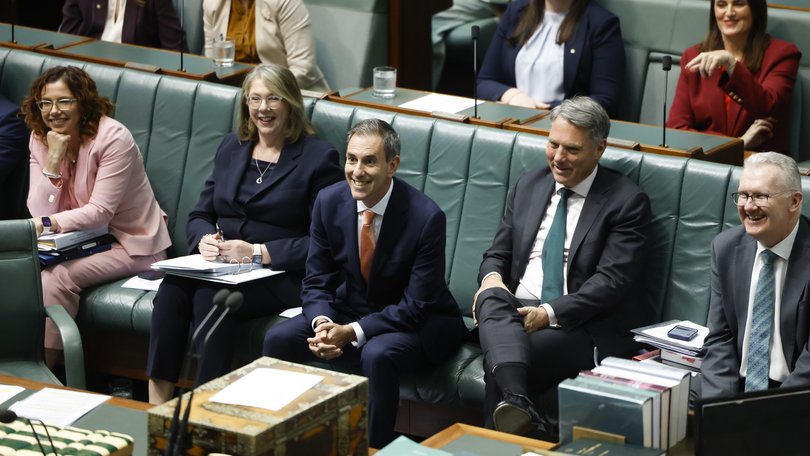 Treasurer of Australia Jim Chalmers (c) and members of the government front bench laugh in the House of Representatives in Parliament House on September 16, 2026 in Canberra, Australia.