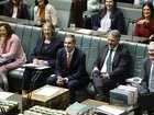Treasurer of Australia Jim Chalmers (c) and members of the government front bench laugh in the House of Representatives in Parliament House on September 16, 2026 in Canberra, Australia.