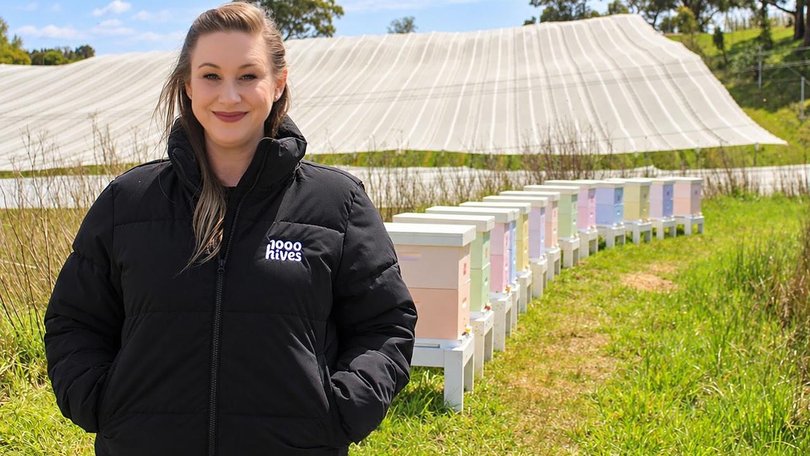 Danielle Munn, founder of 1000 Hives, is proud of the project's first beehives in an apple orchard. (PR IMAGE PHOTO)