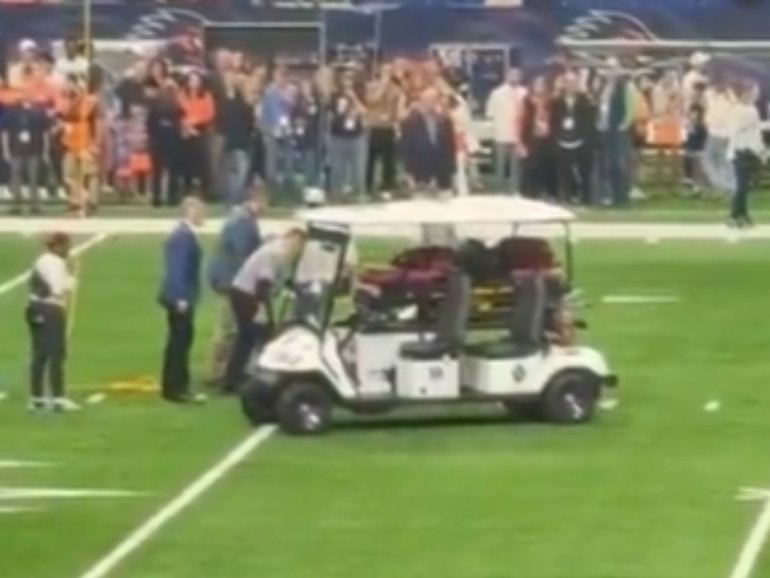 A military service member died after falling hard as he rappelled from the ceiling before a college football game.