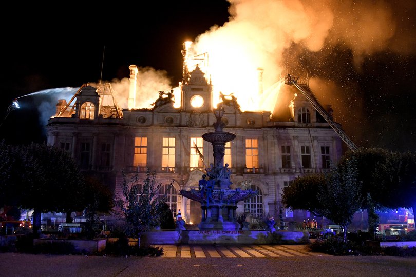 This photograph shows a fire burning and destroying the city hall in Limoges, central France.