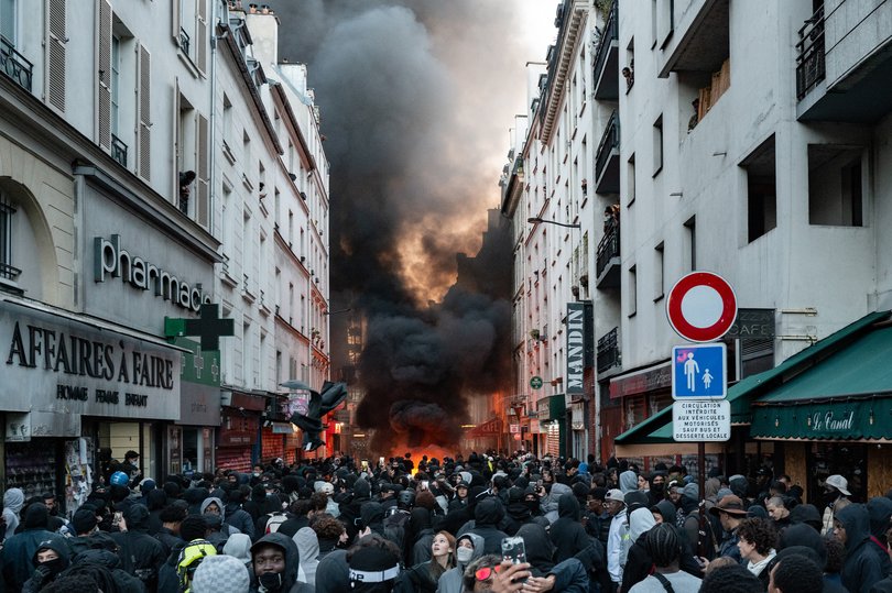 Protesters set up barricades and burn materials near Place de la Republique in Paris, France, on October 18, 2026, the day following a large demonstration.