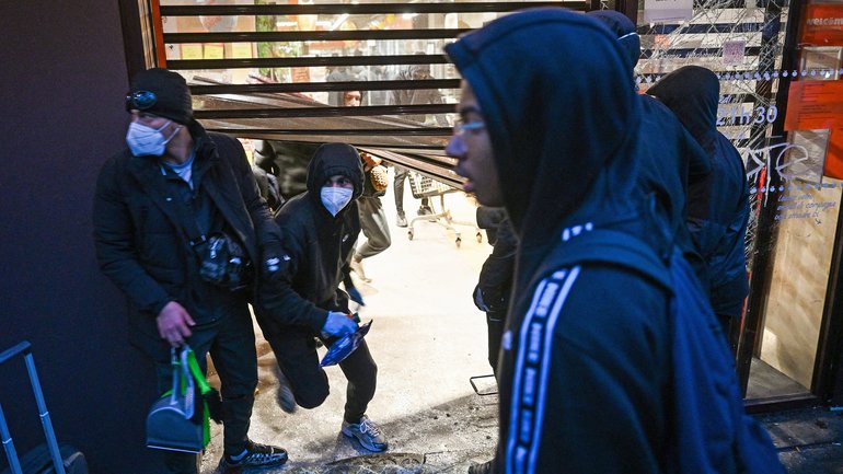 People enter a ransacked Franprix store as clashes erupted at Place de la Republique following an unauthorised demonstration on Sunday.
