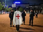 French police officers check a person during a partial curfew in Lyon.