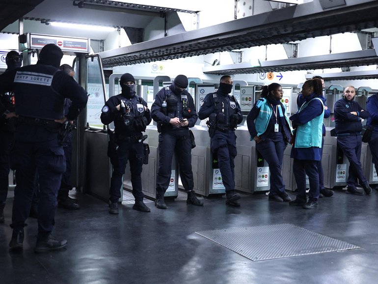 RATP transport security officers inside the closed off Republique Metro station in Paris.
