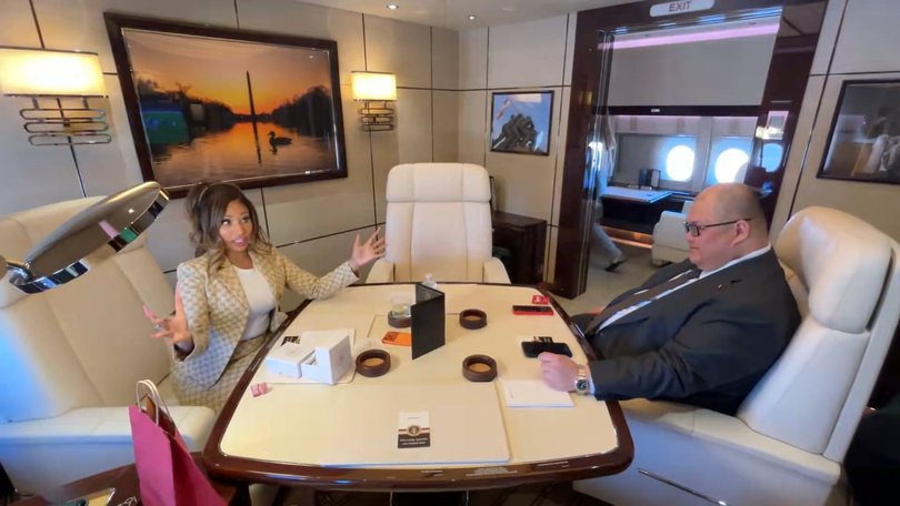 Nicki Minaj speaks with White House communications director Steven Cheung aboard Air Force One en route to President Donald Trump's rally in Michigan.