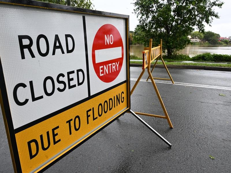 Flood warnings are in place across Queensland's rain-soaked southeast with a wet weekend forecast. (Darren England/AAP PHOTOS)
