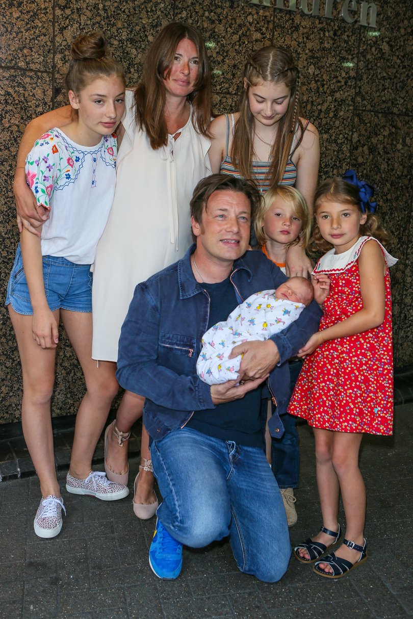 Jamie and Jools Oliver pose with their new baby River Rocket and older children at The Portland Street Hospital on August 8, 2016 in London.