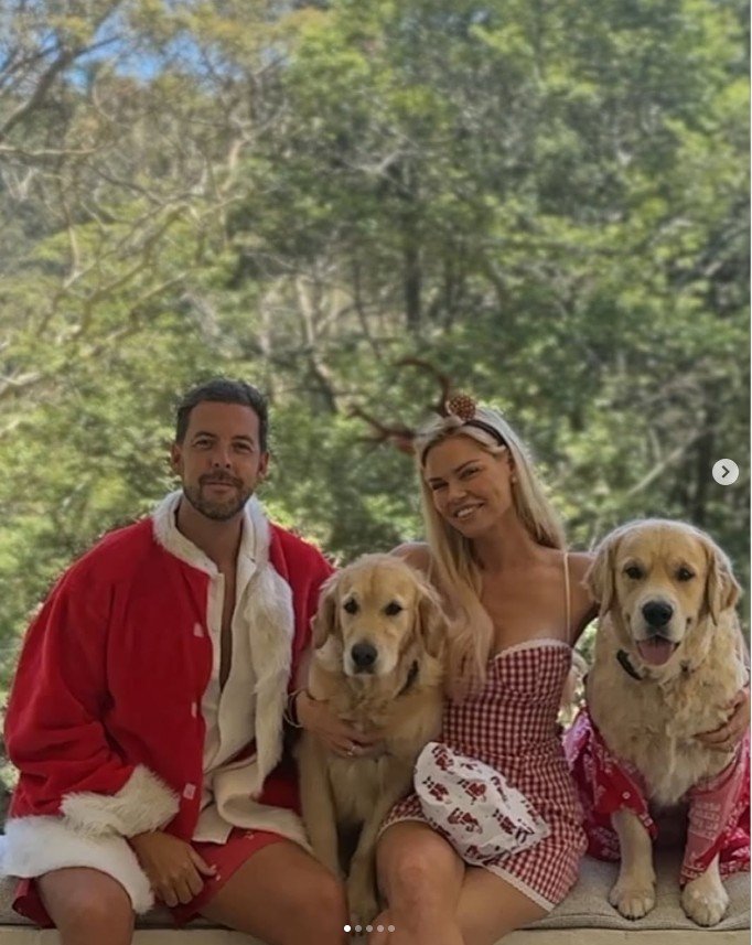 Monk and Gross celebrating Christmas with their two dogs.