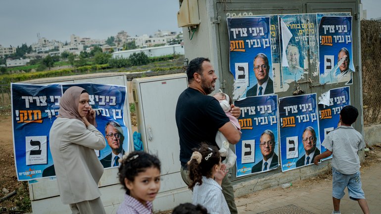 A Palestinian family walks past election campaign posters for Israel's National Security Minister and Otzma Yehudit party leader Itamar Ben Gvir on October 27, 2026 in Beit Kahil, West Bank. 