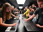 Attendees try out the new touchscreen MacBook Pro during the Apple Experience LA in Los Angeles, Oct. 28, 2026.