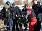 A paramedic and police officers carry a person injured at a railway station during a Russian drone strike, amid Russia's attack on Ukraine, in Dnipro.