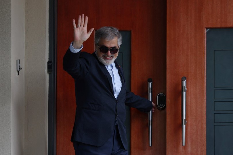 Former Iranian ambassador to Australia Ahmad Sadeghi waves outside his residence after being expelled.