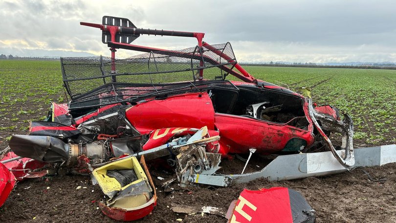 Authorities are examining the wreckage of two helicopters that collided near an airport in Oregon. (AP PHOTO)